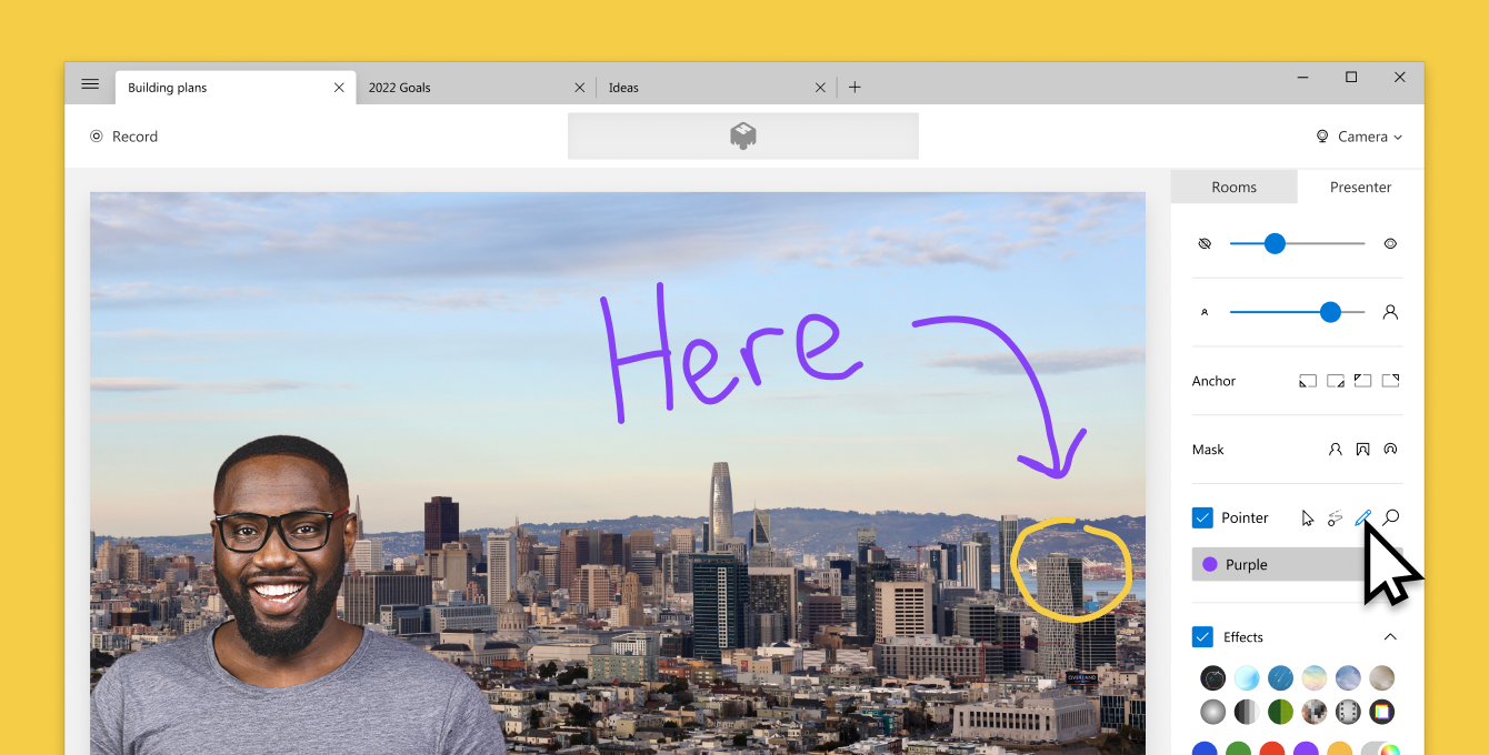 Screenshot of mmhmm with man standing in front of a city background with a drawing of the word "Here"