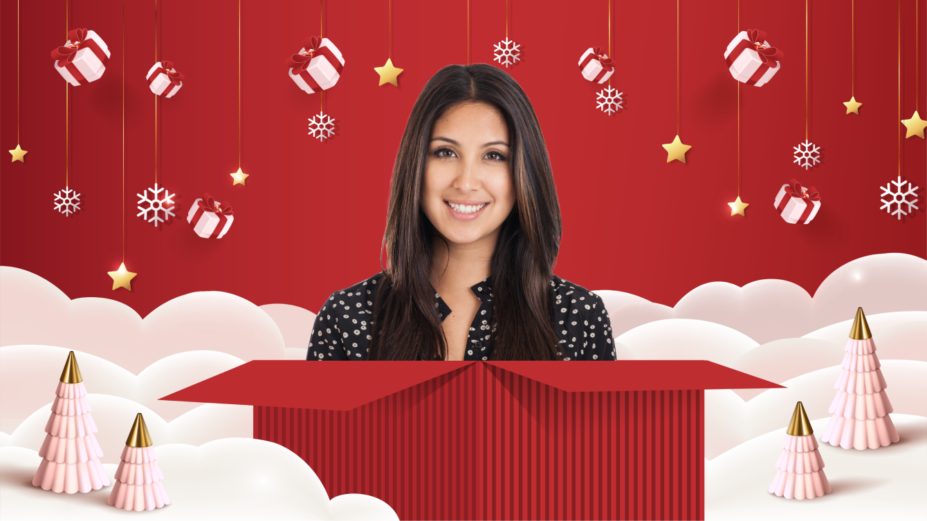 woman with dark hair and a black and white shirt popping out of a red gift box