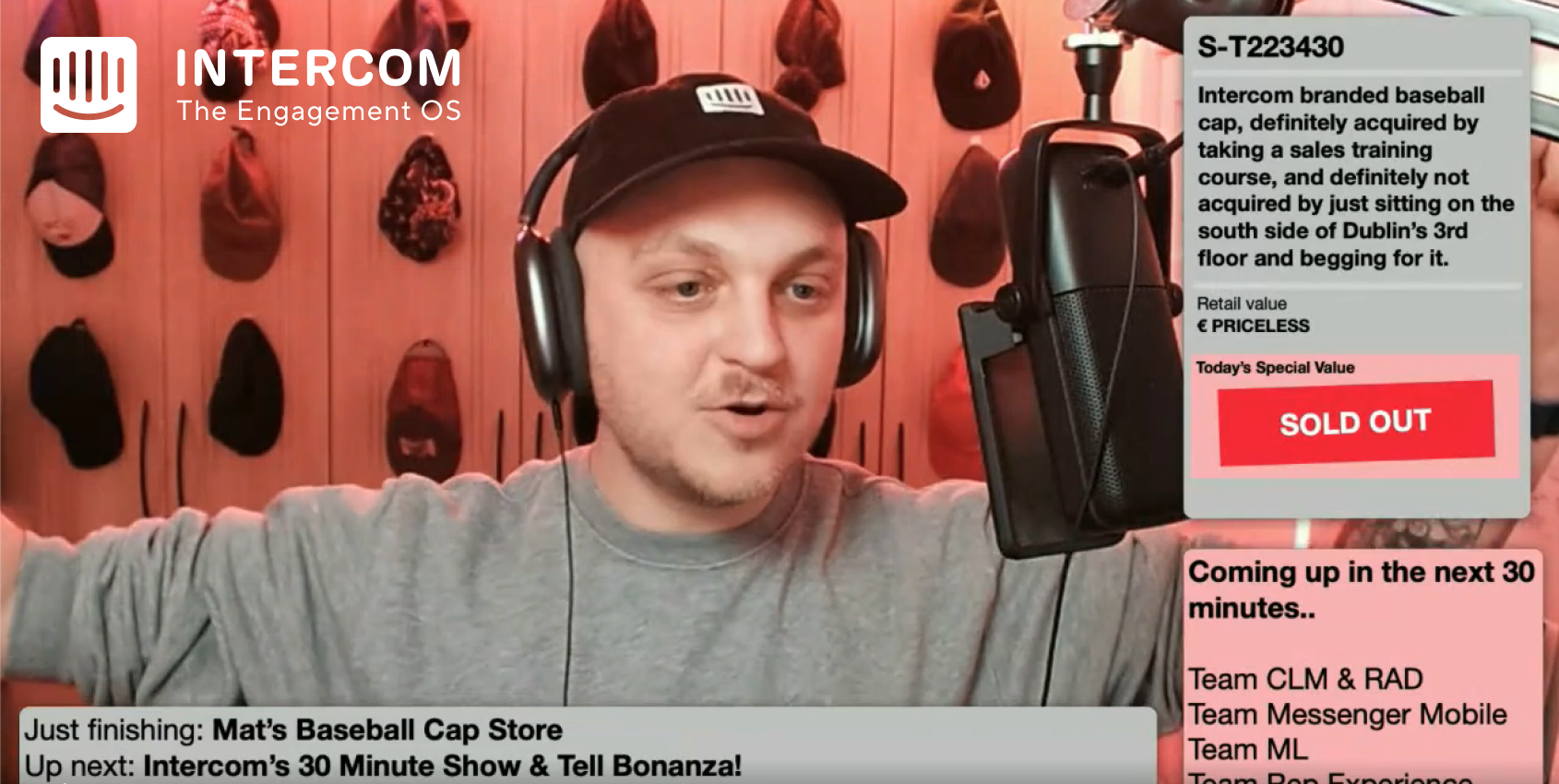 Matthew Cropper in black hat, headphones, gray sweatshirt, speaking into large microphone
