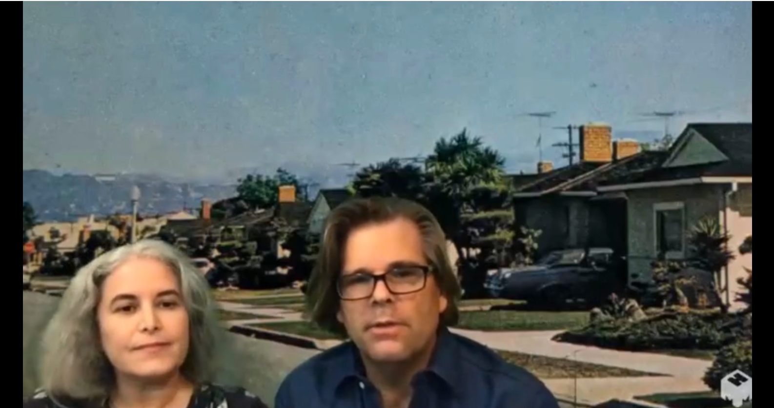 Kim Cooper and Richard Schave in front of a photo from the 70s in Leimert Park